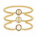 Pulsera de cuentas doradas con dije